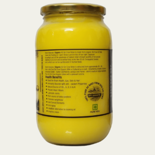 Image of Heere Naturals A2 Gir Cow Pure Aromatic Ghee - a jar filled with golden, creamy ghee, showcasing its rich texture and purity