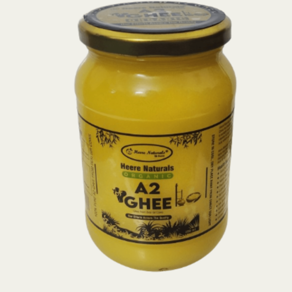 Image of Heere Naturals A2 Gir Cow Pure Aromatic Ghee - a jar filled with golden, creamy ghee, showcasing its rich texture and purity