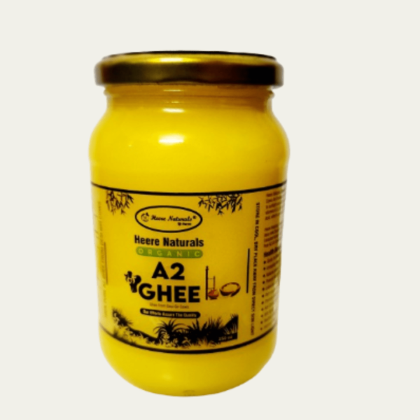 Image of Heere Naturals A2 Gir Cow Pure Aromatic Ghee - a jar filled with golden, creamy ghee, showcasing its rich texture and purity